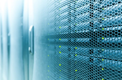 Närbild av serverutrustning bakom perforerad panel i datacenter med synliga statuslampor, vilket illustrerar IT‑infrastruktur som tjänst, säker drift, övervakning och stabil hantering av system i modern IT‑miljö