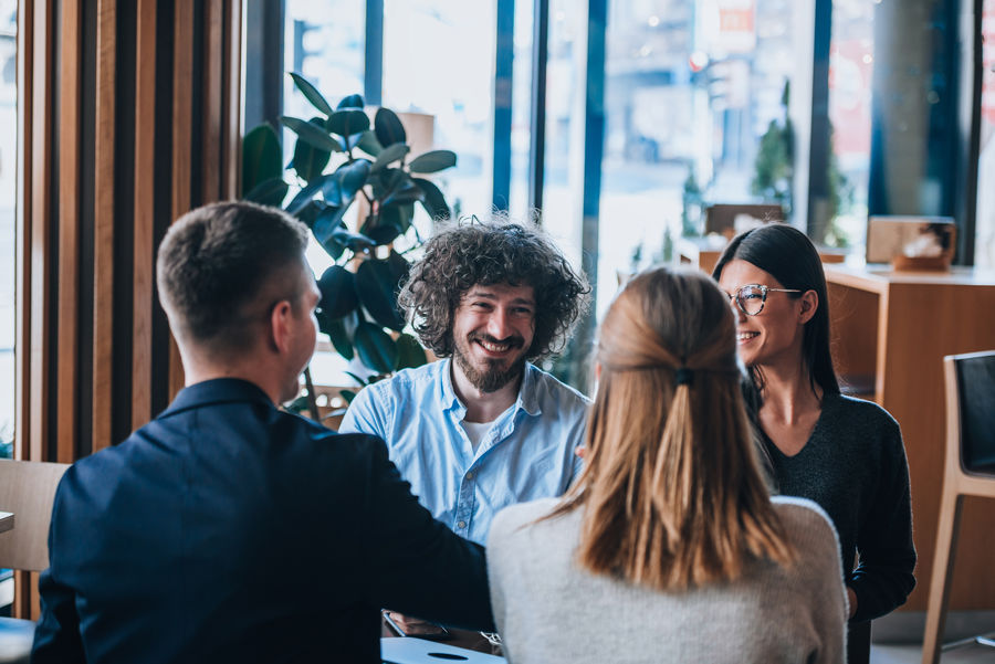 Stock Photo Group Of Coworkers During A Brainstorming Session At A Coffee Shop 1675199065