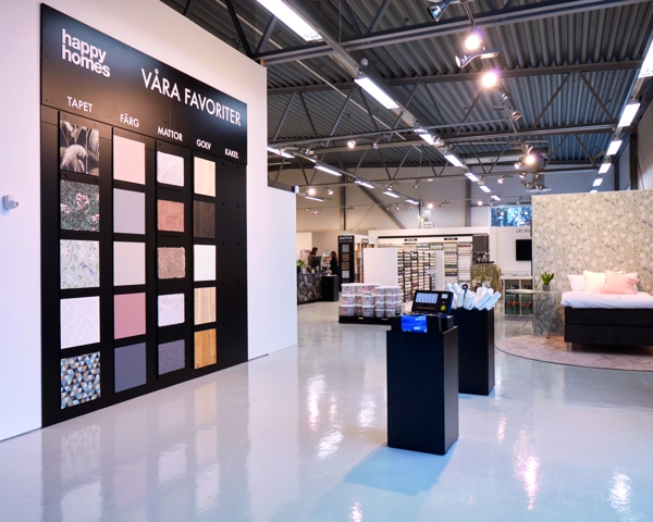 Interiör i Happy Homes-butik med inspirerande utställningar för tapeter, färg, golv, kakel och heminredning i modern butiksmiljö